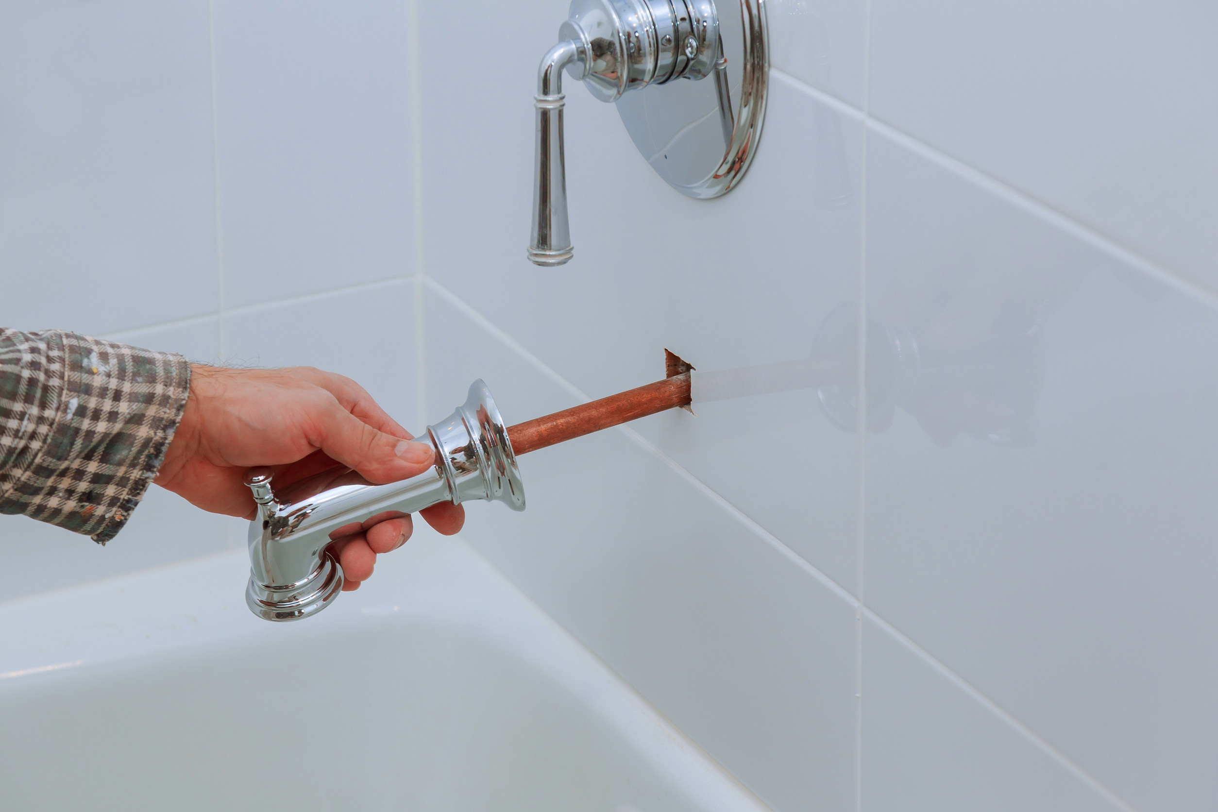 Plumber installing water faucet