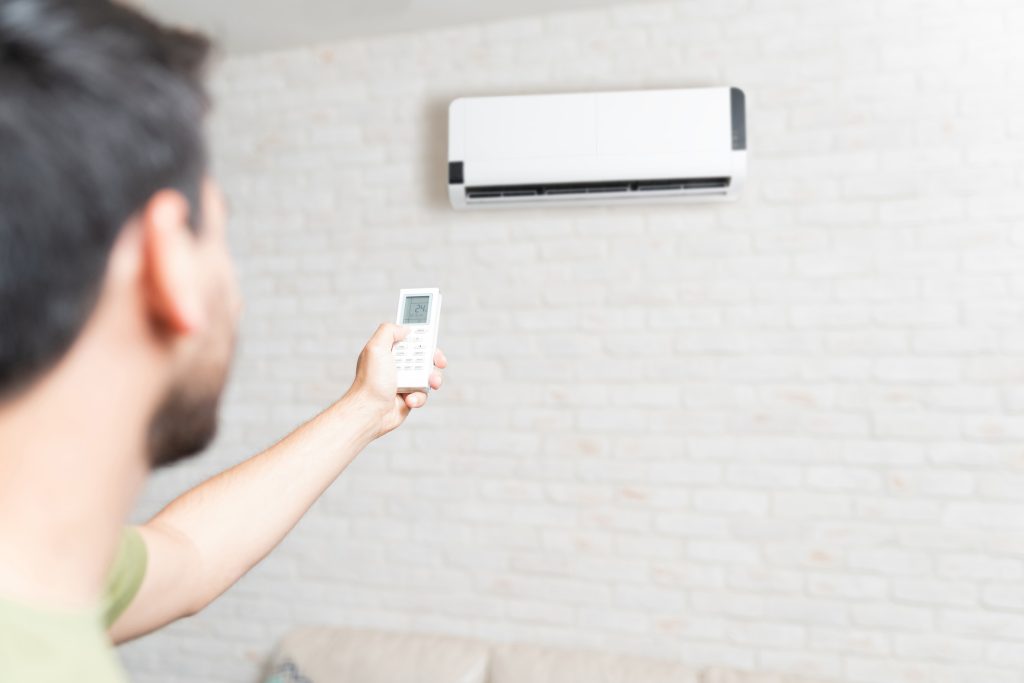 Certified engineer performing professional heating and plumbing services in a Cobham home